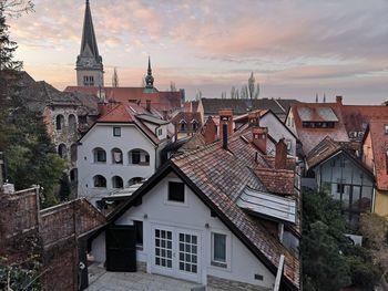 Buildings in city against cloudy sky