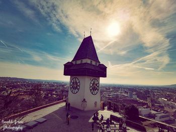 Clock tower in city against sky