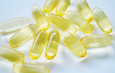 Close-up of yellow and spoon on white background