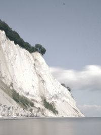 Scenic view of sea and mountain against sky