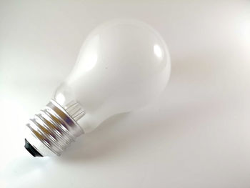 Close-up of light bulb against white background