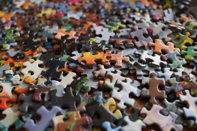 High angle view of multi colored puzzle pieces on table