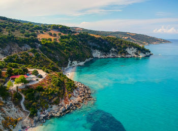 Drone aerial view of a stony beach. panorama with nice sand, lagoon and clear blue water.