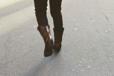 Low section of man standing on road