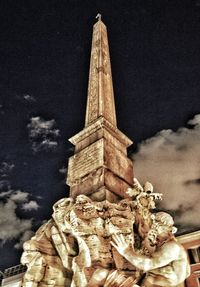 Low angle view of statue against sky at night