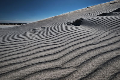 Sand dune in desert against sky