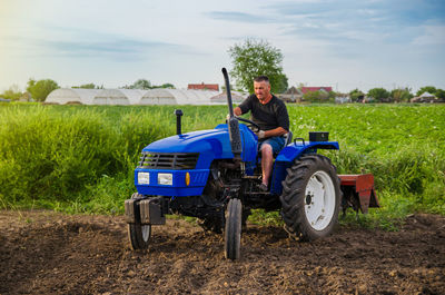 Farmer rides a tractor across the field. milling soil. work in the field and preparation of the land 