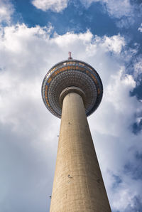 Low angle view of tower against cloudy sky