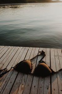 Bra on pier over lake during sunset