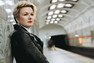 Portrait of young man standing in subway