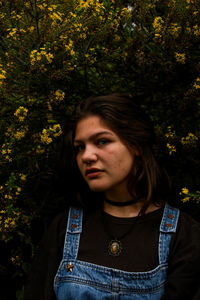 Close-up of beautiful young woman against trees