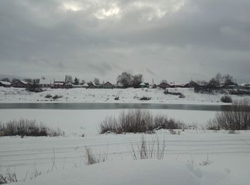 Scenic view of snow covered landscape against sky