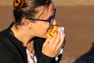 Close-up of woman eating burger