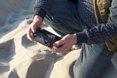 Male hands holding drone remote controller. cropped shot, close up.