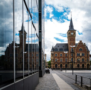 Buildings in city of cologne against cloudy sky