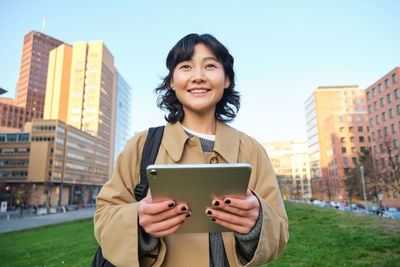 Portrait of young woman using mobile phone