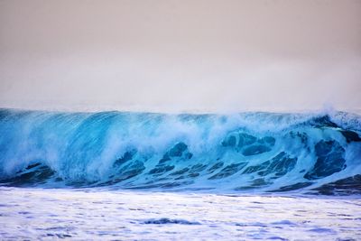 Scenic view of sea waves against sky