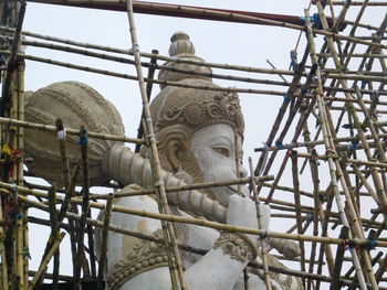 Low angle view of statue against sky