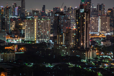 High angle view of illuminated buildings in city at night