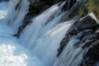 Scenic view of waterfall against sky