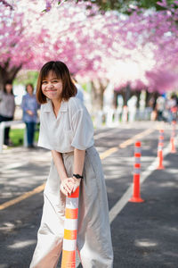 Portrait of smiling young woman standing outdoors