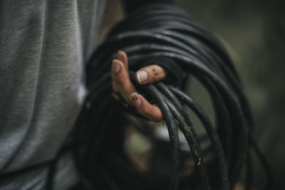 Close-up of woman holding cables