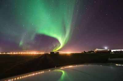 Scenic view of illuminated landscape against sky at night