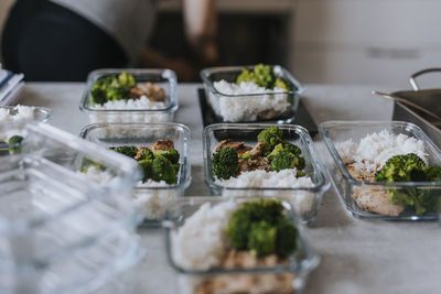 Identical lunch boxes on kitchen counter as part of meal prep