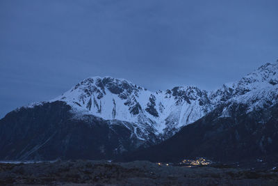 Scenic view of snowcapped mountains against clear blue sky