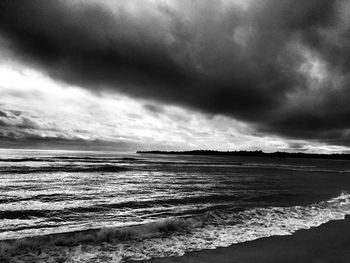 Scenic view of sea against cloudy sky