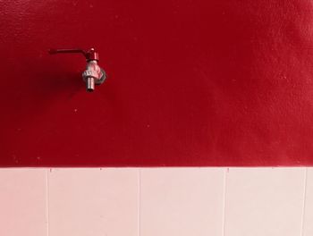 Man jumping on red wall