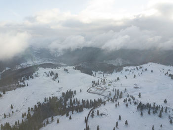 Scenic view of snow covered mountains against sky