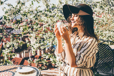 Midsection of woman drinking glass