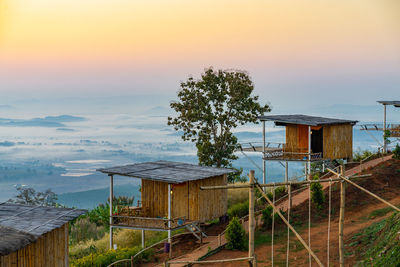 House by building against sky during sunset