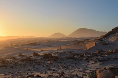 Scenic view of snowcapped mountains against sky during sunset