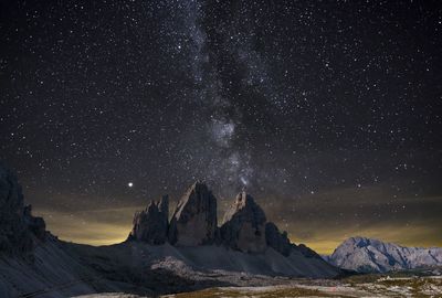 Scenic view of rocky mountains against star field