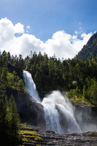 Scenic view of waterfall against sky