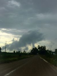 Empty road against cloudy sky