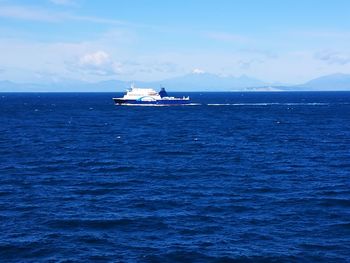 Boat sailing in sea against sky