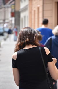 Rear view of women walking in city