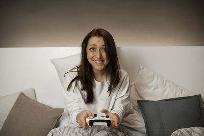 Portrait of smiling woman sitting on sofa