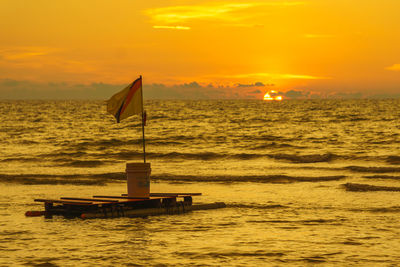 Scenic view of sea against orange sky