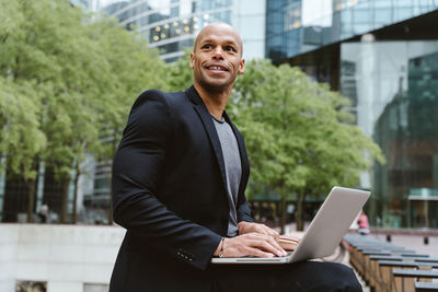 Portrait of young man using laptop