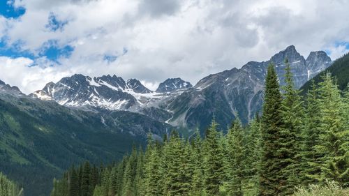 Scenic view of mountains against cloudy sky