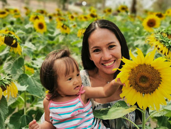 Portrait of mother and daughter on sunflower