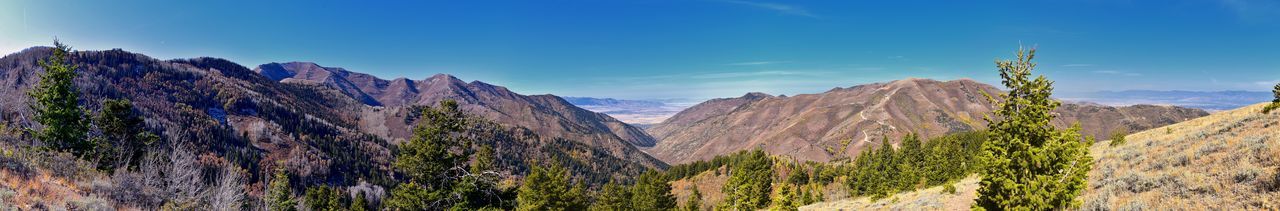 Panoramic view of mountains against blue sky