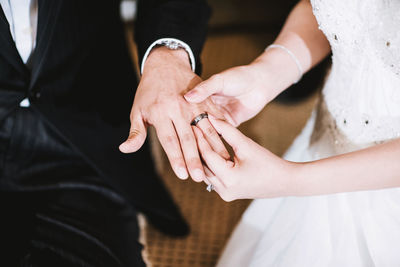 Midsection of couple holding hands