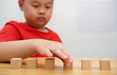 Close-up of boy playing block