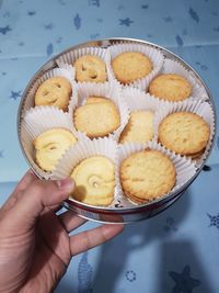 High angle view of hand holding cookies