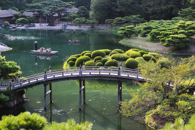 Bridge over lake against trees